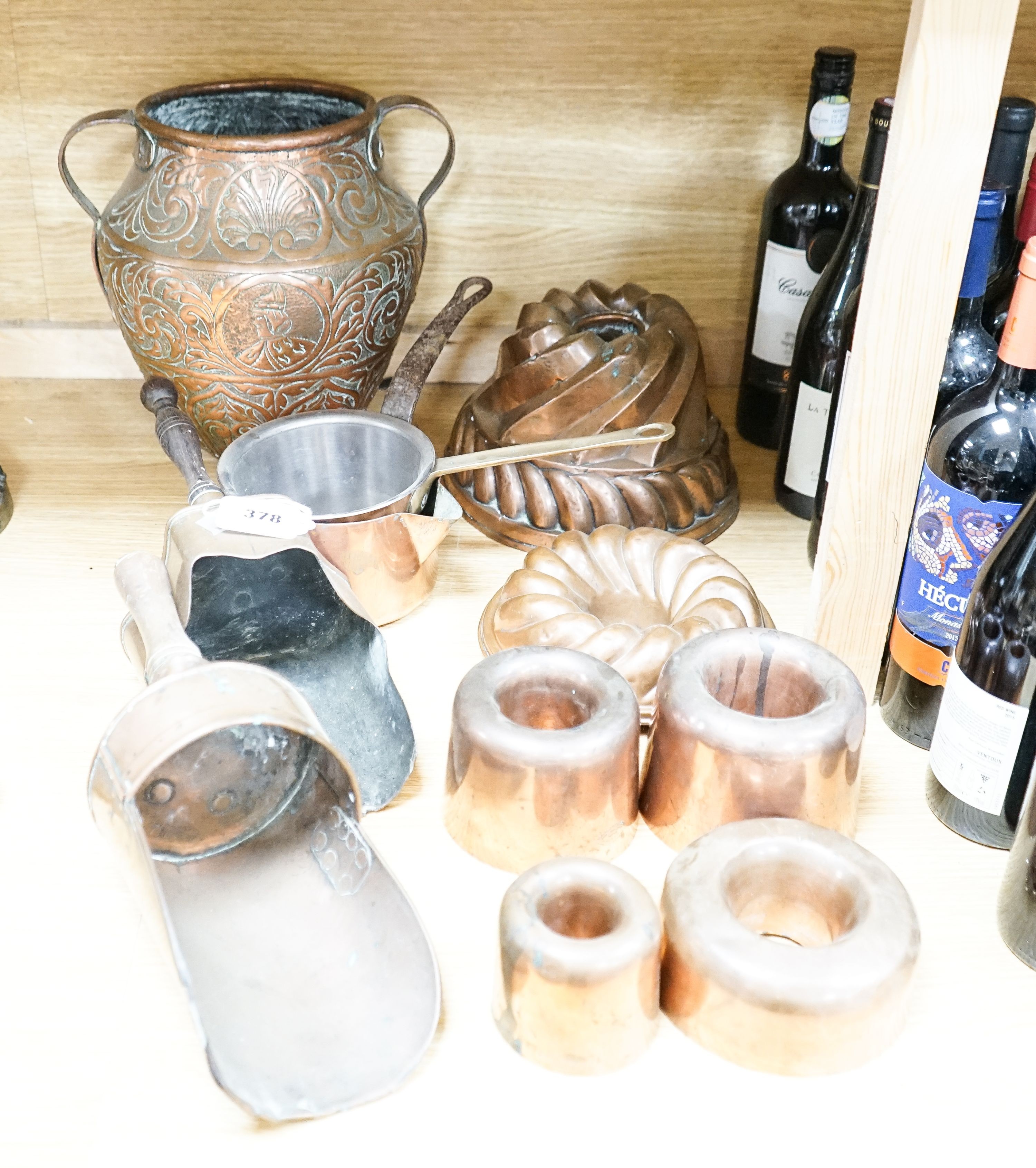 A mixed group of copper wares including Victorian jelly moulds, coal scoops, vase etc